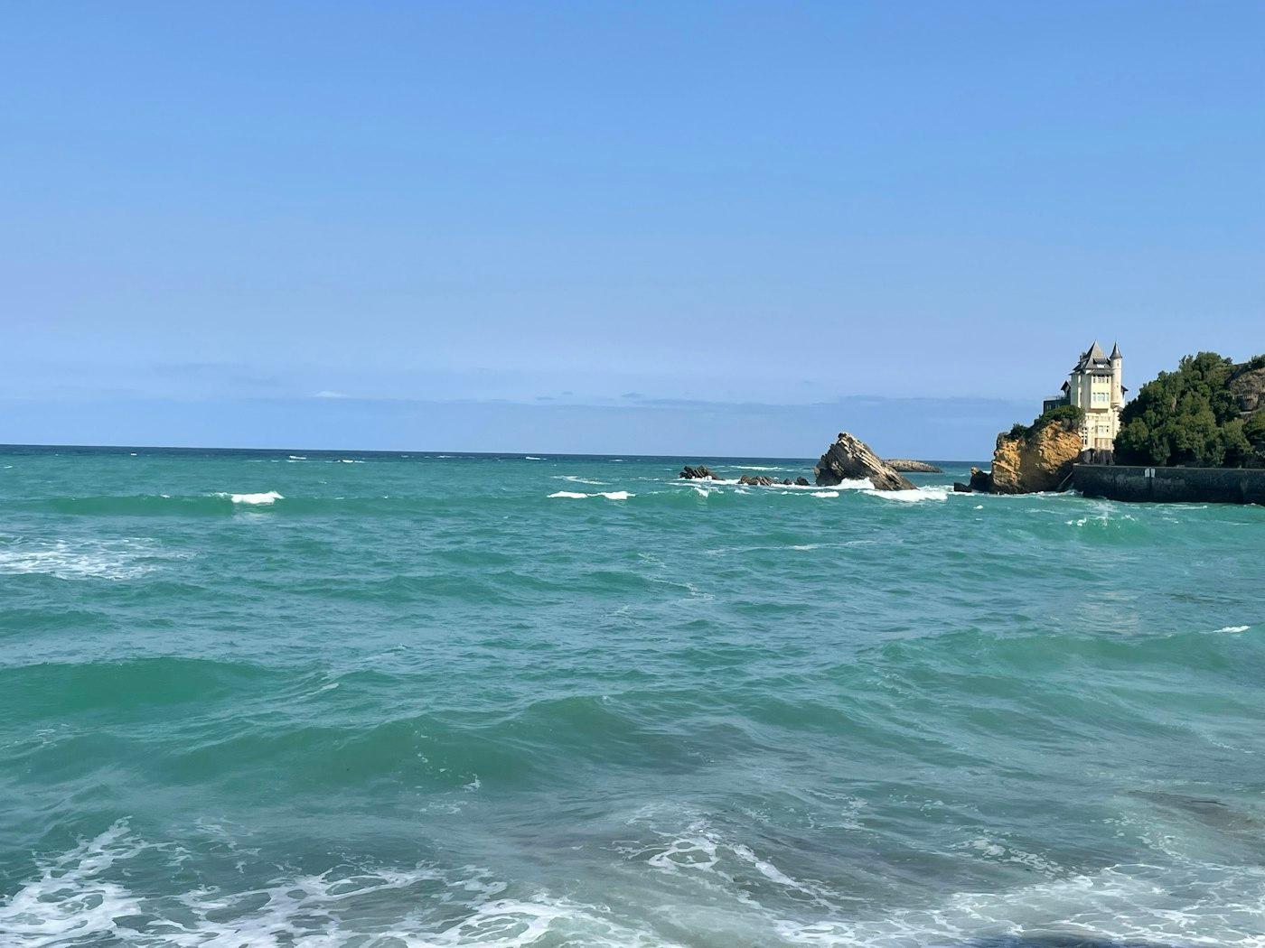 A body of water with a castle on the shore