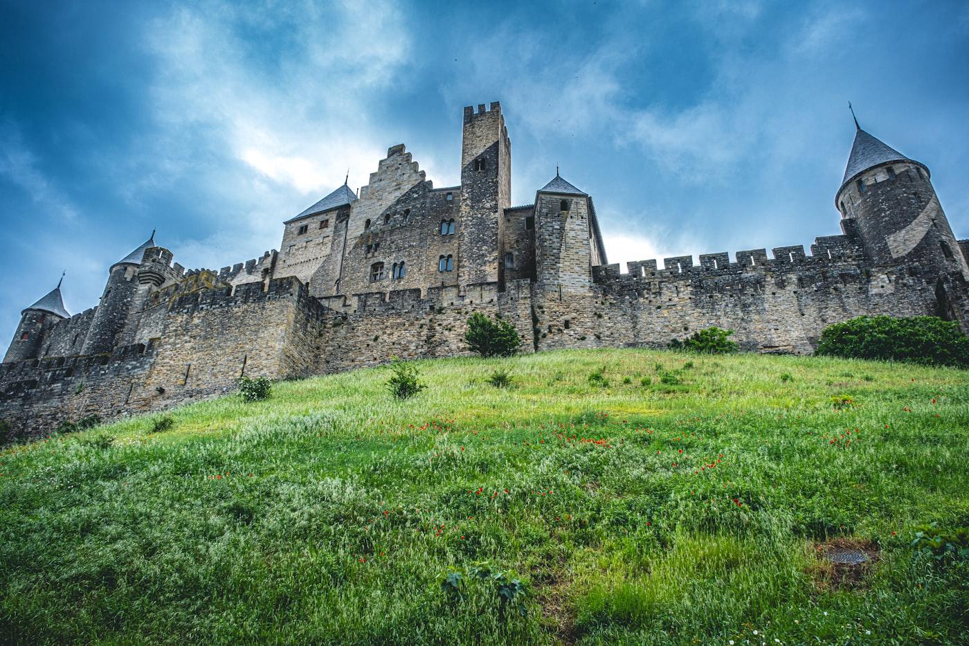 Ancient castle stands on a grassy hill