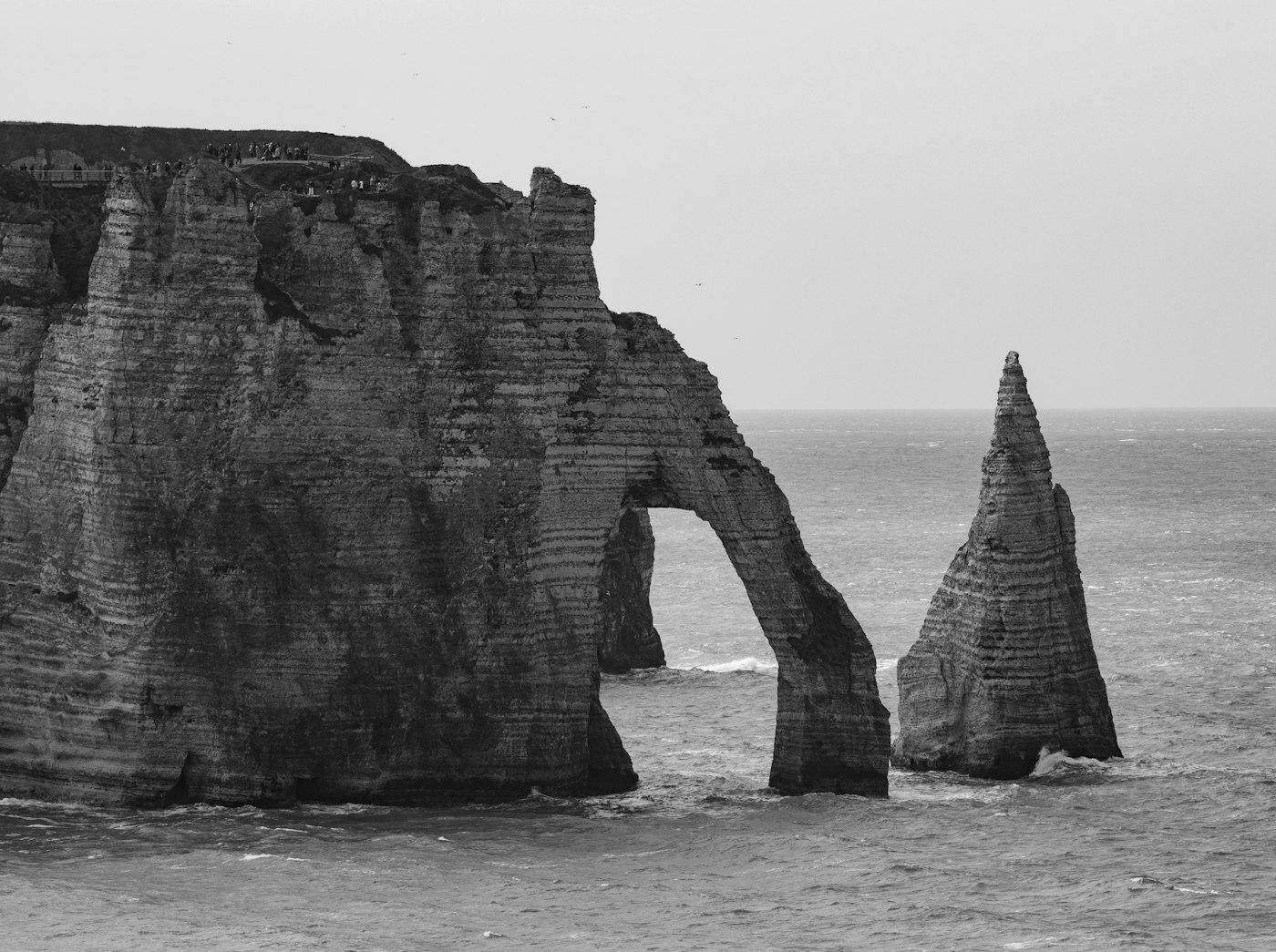 Monochromatic cliffs and natural arch over the ocean