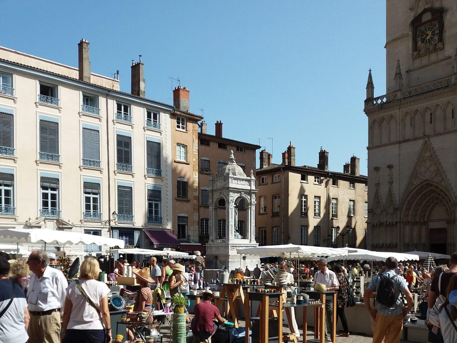 Pale facades and cobbles on the place Saint-Jean in old Lyon