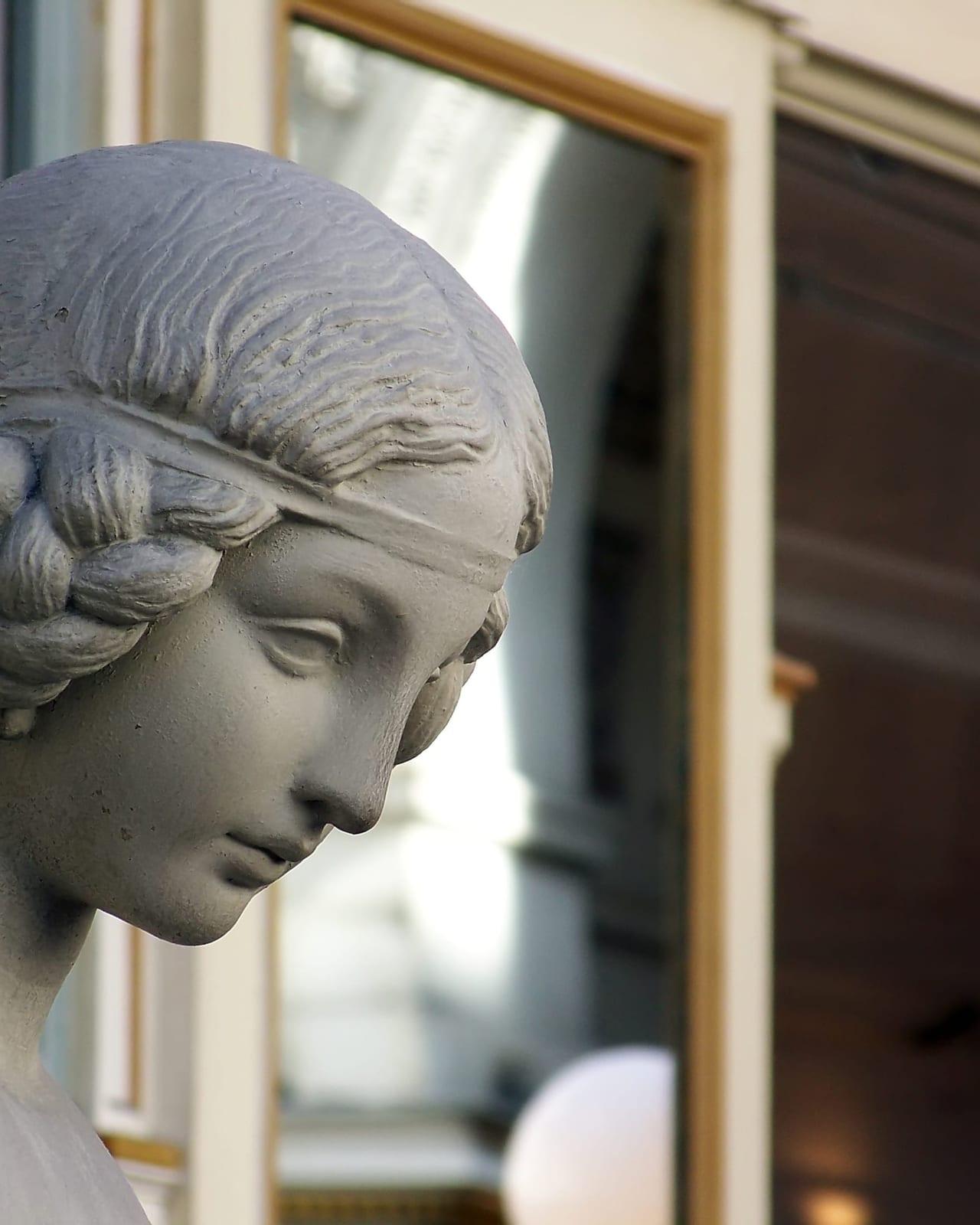 The carved face of a statue in the Passage Pommeraye