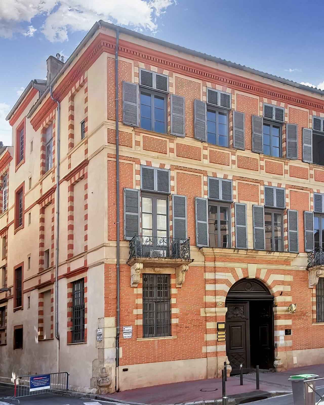 The brick facade of a Toulouse town house